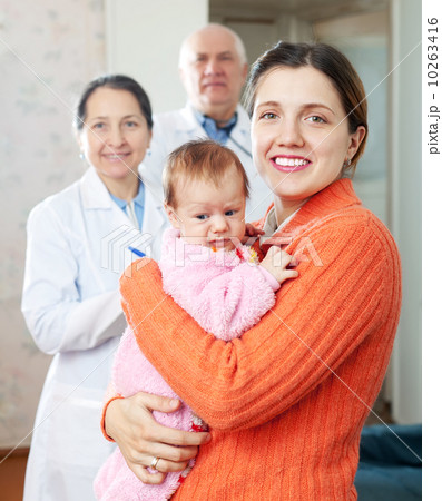 woman holding baby with doctors woman holding baby with doctors 10263416