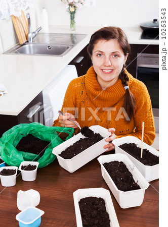 Girl sowing seeds in pots Girl sowing seeds in pots 10263543