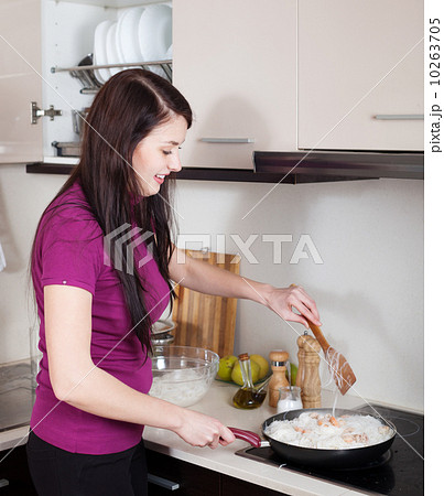 Happy girl cooking rice noodles with seafood Happy girl cooking rice noodles with seafood 10263705