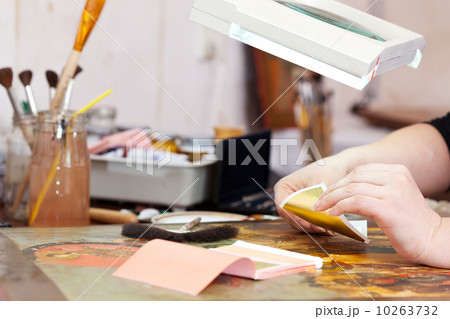 Restorer gilding on the old Christian icon 10263732