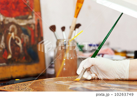 Artist works on icon with brush 10263749