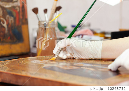 restorer works on ancient gilded icon 10263752