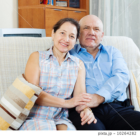 mature couple together on sofa mature couple together on sofa 10264282