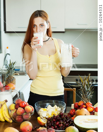ordinary woman drinking milk cocktail with fruits ordinary woman drinking milk cocktail with fruits 10264331