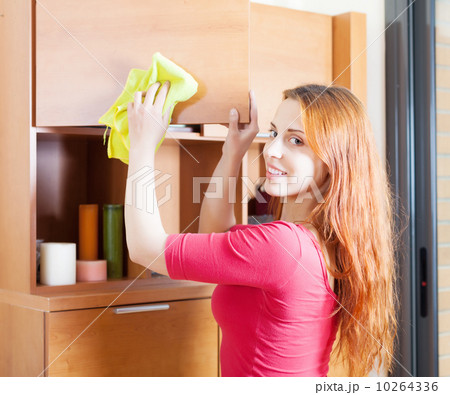 woman in red cleaning wooden furiture woman in red cleaning wooden furiture 10264336