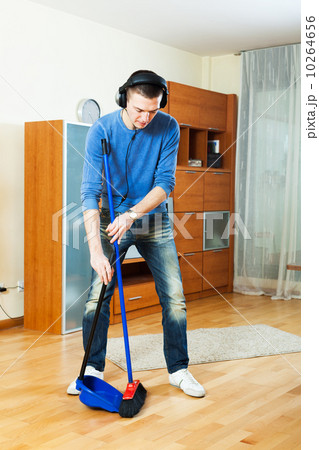 Handsome man cleaning living room 10264656
