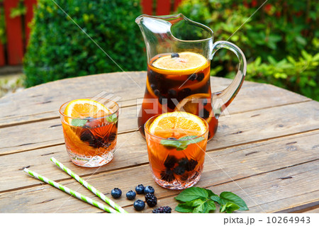 Berry sangria - summer cocktail, decorated with berries, orange 10264943