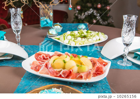 Holiday-decorated table, Christmas tree, ham and melone, and sal Holiday-decorated table, Christmas tree, ham and melone, and sal 10265156