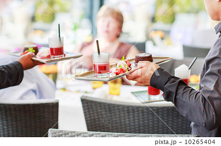 Waiter carrying a plate with salad dish on a wedding. 10265404