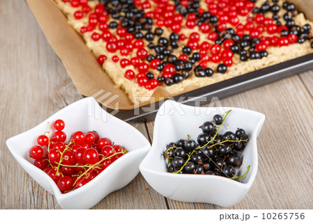 red and black currant berries with home baked cake on background 10265756