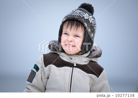 Attractive little boy having fun on winter beach Attractive little boy having fun on winter beach 10277138