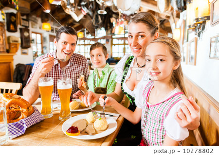 Bavarian family in German restaurant eating 10278802