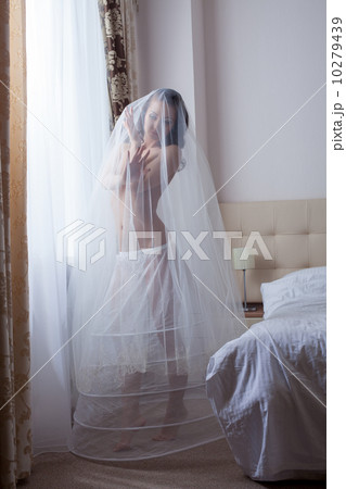 Cute girl posing in wedding petticoat and veil 10279439