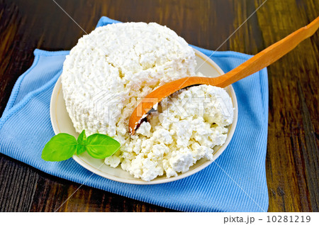 Curd with a wooden spoon on board 10281219