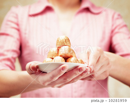 Young woman holding a chocolate candies Young woman holding a chocolate candies 10281959