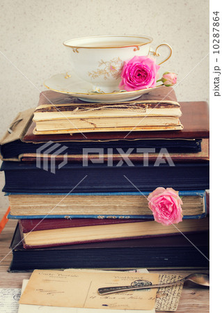 pile of old books and mail with cup of tea pile of old books and mail with cup of tea 10287864