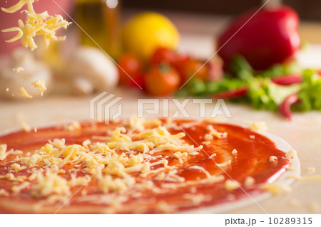 Italian pizza preparation with cheese falling. 10289315