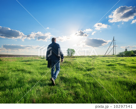 Man walking on the field Man walking on the field 10297541