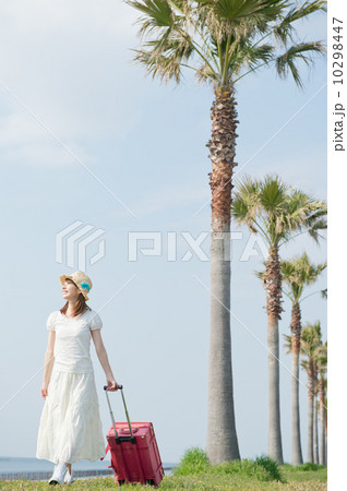スーツケースを持って歩く女性 10298447