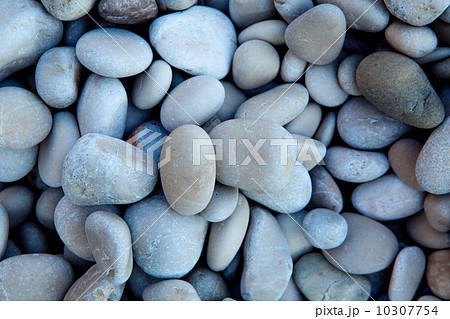Naturally polished white rock pebbles background 10307754