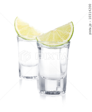 Two shots of vodka and lime slice Two shots of vodka and lime slice 10314200