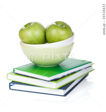 Green apples in fruit bowl and books Green apples in fruit bowl and books 10316833
