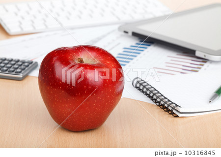 Ripe red apple on workplace 10316845
