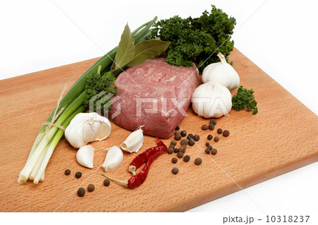 raw meat, vegetables and spices isolated on a wooden table. 10318237