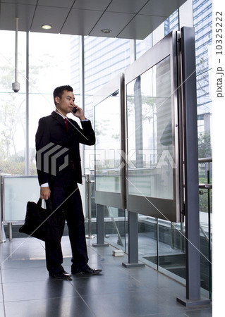 Busy Asian Businessman checking train timetable  10325222