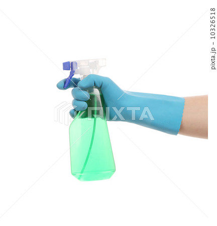 Hand in gloves holds spray bottle. 10326518
