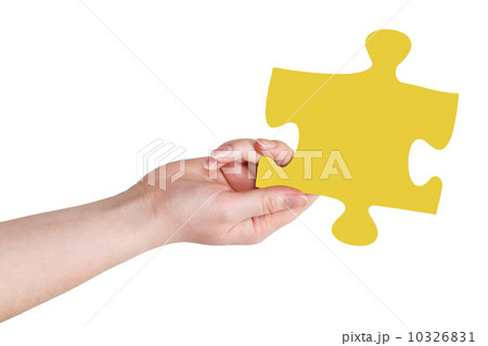 female hand with yellow puzzle piece female hand with yellow puzzle piece 10326831