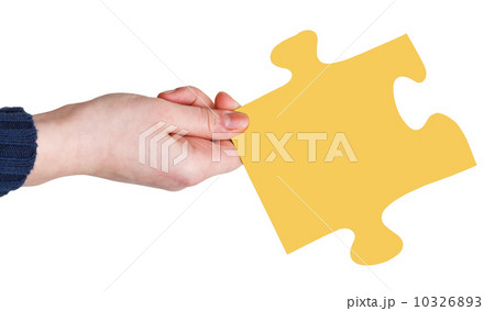 female hand with yellow puzzle piece 10326893