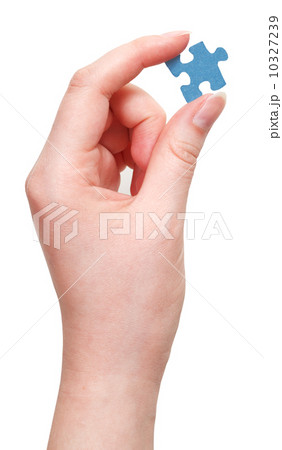 female hand holding blue puzzle piece 10327239