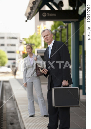 Two business people at a train station Two business people at a train station 10349769