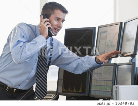 Trader studying computer screens 10349792
