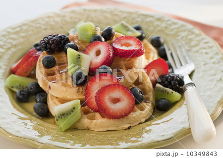 Waffles with berries and kiwi on plate 10349843