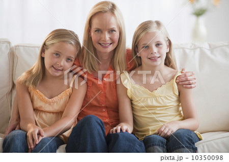 Mother and daughters at home 10350098