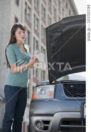 Woman checking oil Woman checking oil 10350298