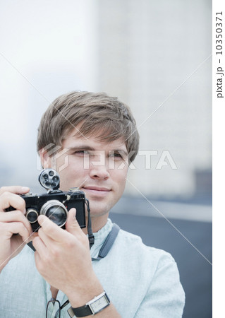 A man with a camera 10350371
