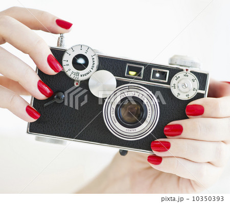Woman holding antique camera 10350393