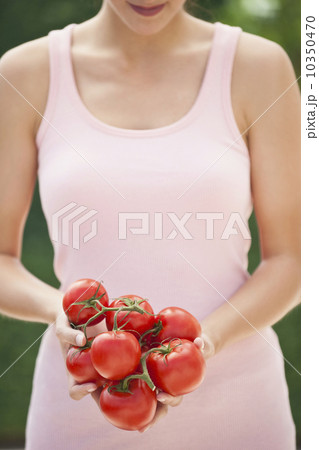 Woman holding tomatoes 10350470