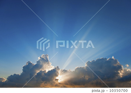 Sunset behind clouds 10350700