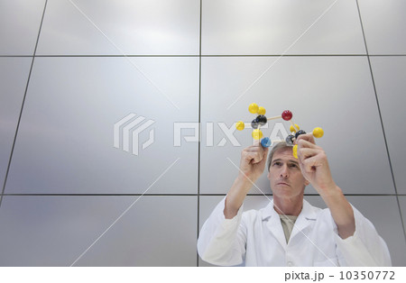 Reseacher holding molecular model 10350772