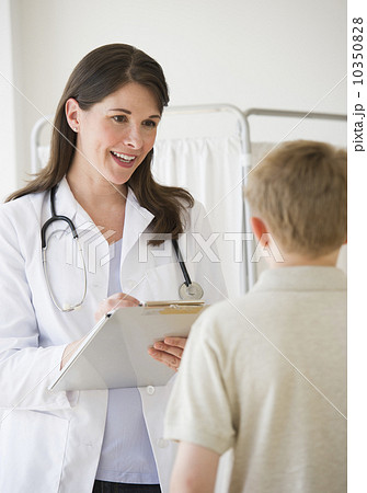 Young boy and doctor in examination room 10350828