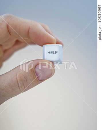 Hand holding keyboard help key 10350997