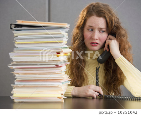 Overworked woman in cubicle 10351042