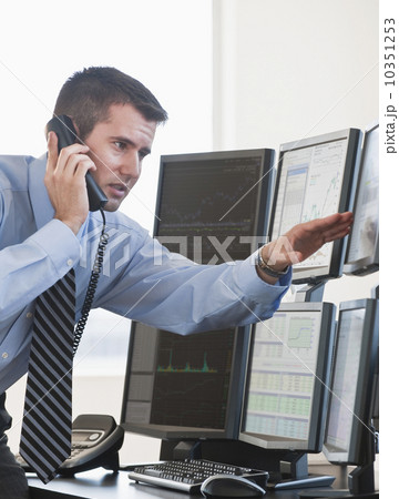 Trader studying computer screens 10351253