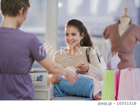 Young girl paying for clothing 10351316