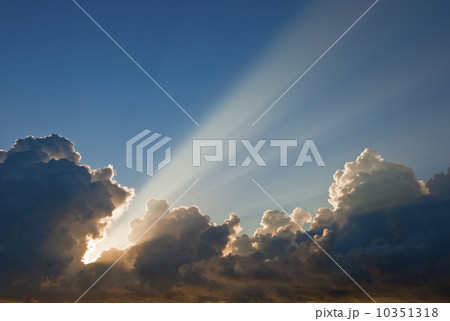 Sunset behind clouds 10351318