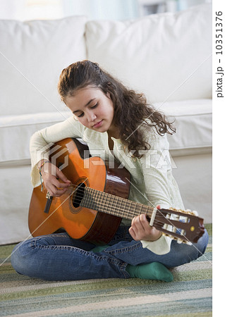 Young girl playing guitar Young girl playing guitar 10351376